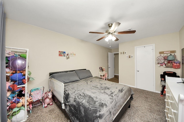 carpeted bedroom with ceiling fan and baseboards
