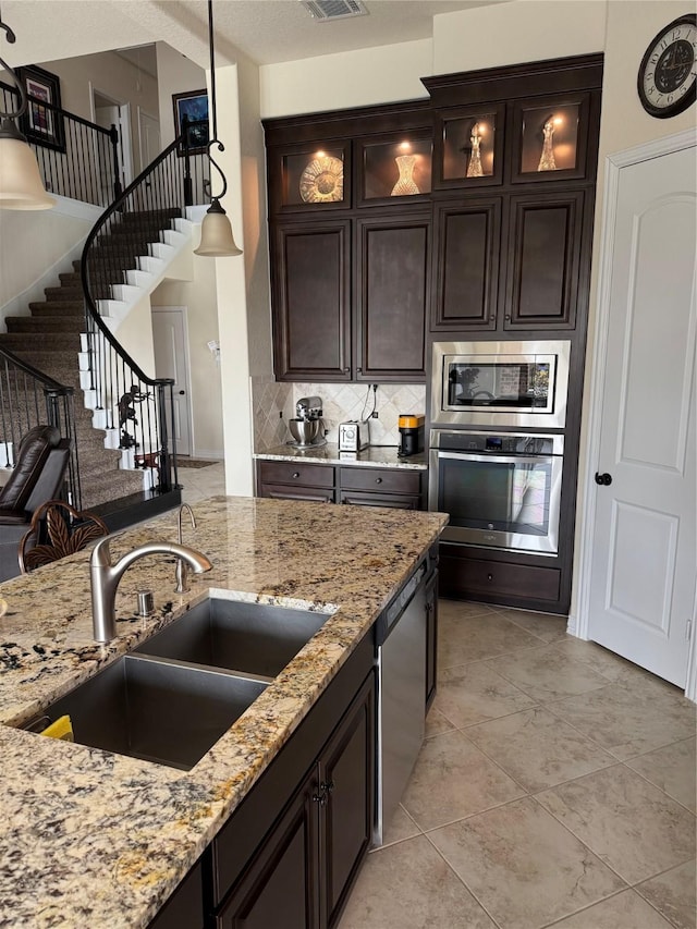 24130 Cannon Anello Ct, Katy, TX 77493 - kitchen featuring appliances with stainless steel finishes, a sink, hanging light fixtures, and light stone countertops
