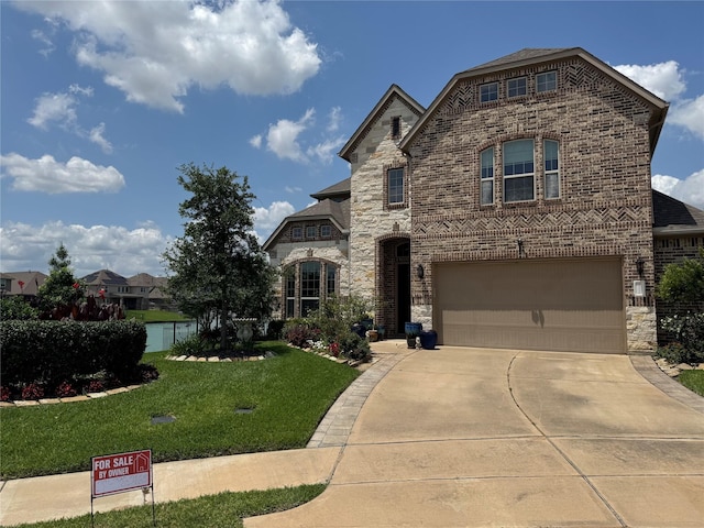 24130 Cannon Anello Ct, Katy, TX 77493 - french country style house featuring a front yard, concrete driveway, stone siding, brick siding, and a garage
