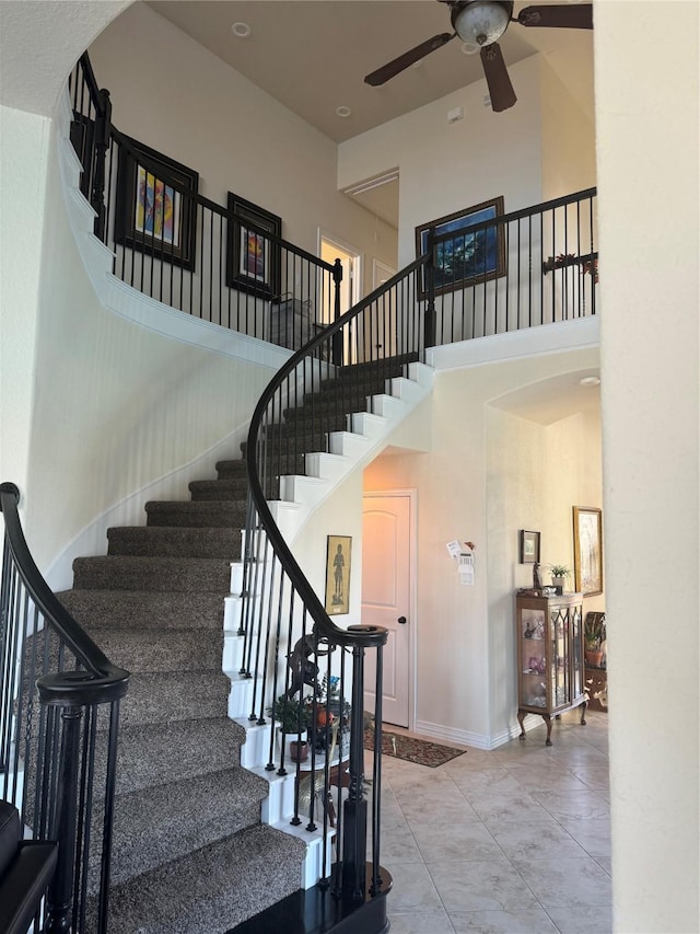 24130 Cannon Anello Ct, Katy, TX 77493 - staircase with ceiling fan, a towering ceiling, baseboards, and tile patterned flooring