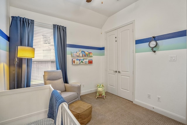 sitting room featuring carpet flooring, vaulted ceiling, baseboards, and ceiling fan
