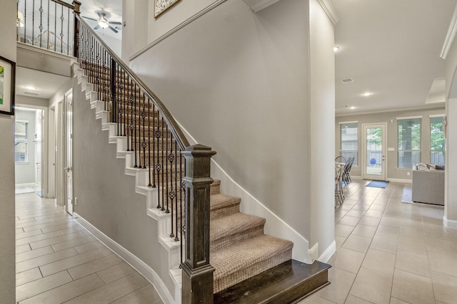 staircase featuring tile patterned flooring, baseboards, crown molding, a ceiling fan, and recessed lighting