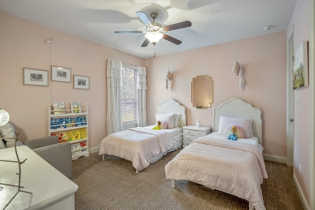 carpeted bedroom featuring baseboards and ceiling fan