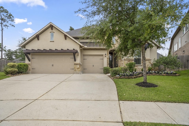 view of front of house with stucco siding, stone siding, concrete driveway, and a standing seam roof