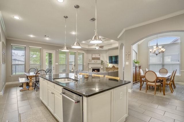 kitchen featuring a sink, dishwasher, plenty of natural light, baseboards, and crown molding