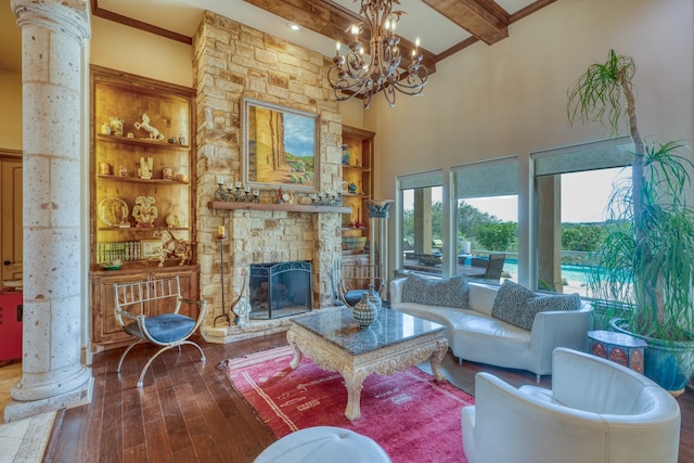 143 Westgate Loop, Horseshoe Bay, TX 78657 - living room with beamed ceiling, hardwood / wood-style flooring, a towering ceiling, a fireplace, and a chandelier