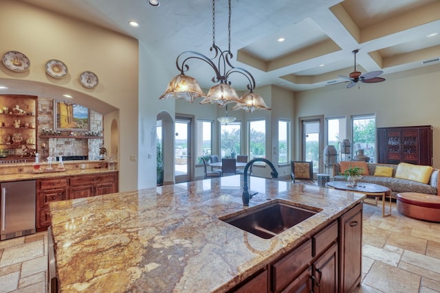 143 Westgate Loop, Horseshoe Bay, TX 78657 - kitchen with a high ceiling, a sink, stainless steel refrigerator, recessed lighting, and open floor plan