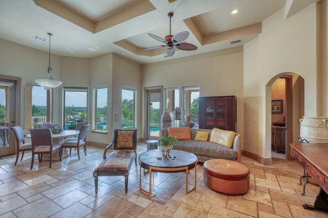 143 Westgate Loop, Horseshoe Bay, TX 78657 - living area with a high ceiling, stone tile floors, arched walkways, recessed lighting, and baseboards