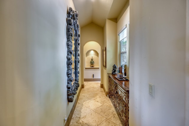 143 Westgate Loop, Horseshoe Bay, TX 78657 - hallway with vaulted ceiling, light tile patterned flooring, and baseboards