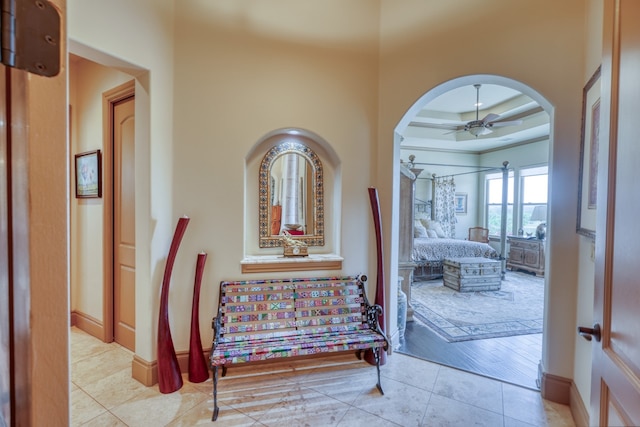 143 Westgate Loop, Horseshoe Bay, TX 78657 - hallway featuring arched walkways, baseboards, and light tile patterned floors