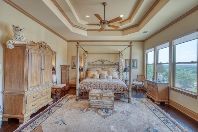 143 Westgate Loop, Horseshoe Bay, TX 78657 - bedroom with crown molding, wood finished floors, a tray ceiling, and baseboards