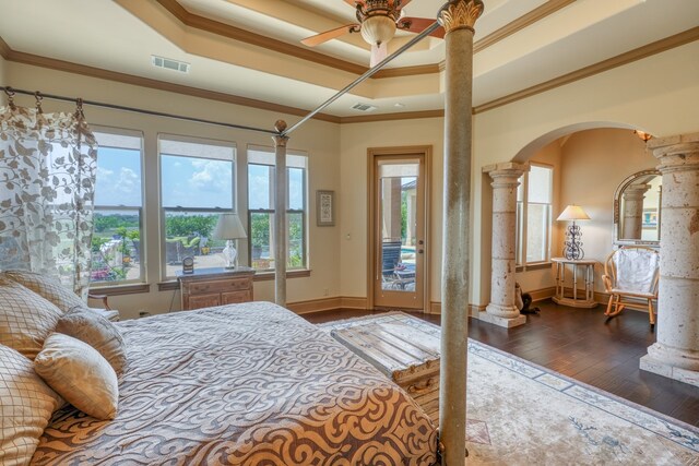 143 Westgate Loop, Horseshoe Bay, TX 78657 - bedroom featuring decorative columns, ornamental molding, arched walkways, wood-type flooring, and baseboards