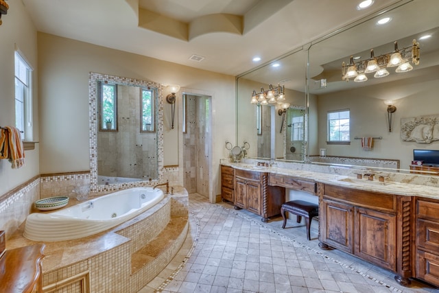 143 Westgate Loop, Horseshoe Bay, TX 78657 - full bath with recessed lighting, a tile shower, a jetted tub, and vanity