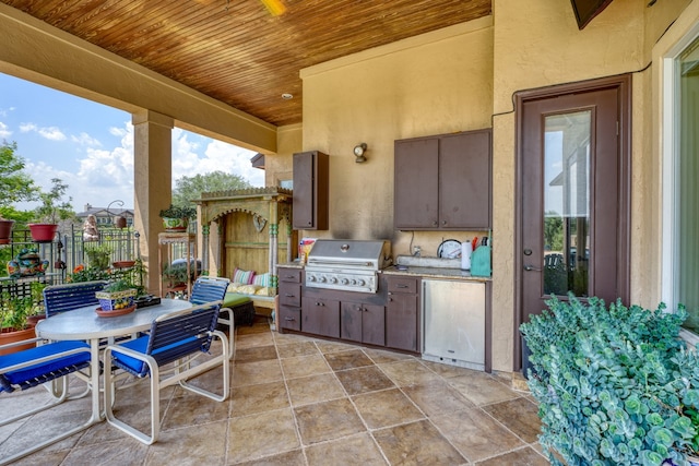 143 Westgate Loop, Horseshoe Bay, TX 78657 - view of patio with grilling area, exterior kitchen, and fence