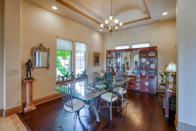 143 Westgate Loop, Horseshoe Bay, TX 78657 - dining room with a chandelier, a towering ceiling, a tray ceiling, hardwood / wood-style floors, and recessed lighting