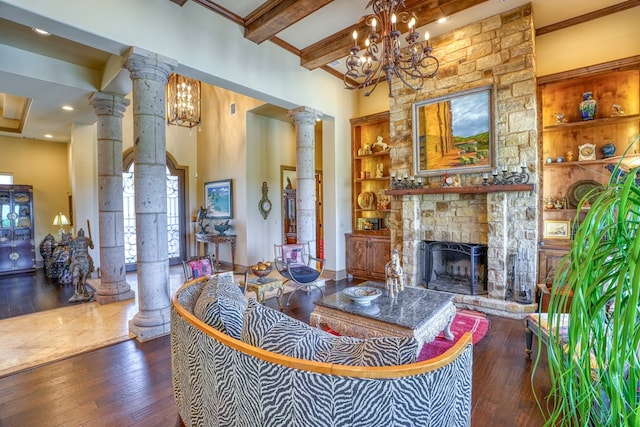 143 Westgate Loop, Horseshoe Bay, TX 78657 - living room featuring ornate columns, hardwood / wood-style flooring, a chandelier, a stone fireplace, and beam ceiling