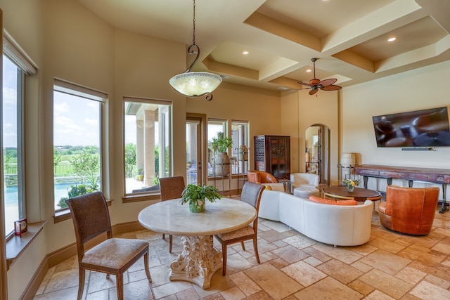 143 Westgate Loop, Horseshoe Bay, TX 78657 - dining area with a towering ceiling, arched walkways, coffered ceiling, plenty of natural light, and stone tile floors