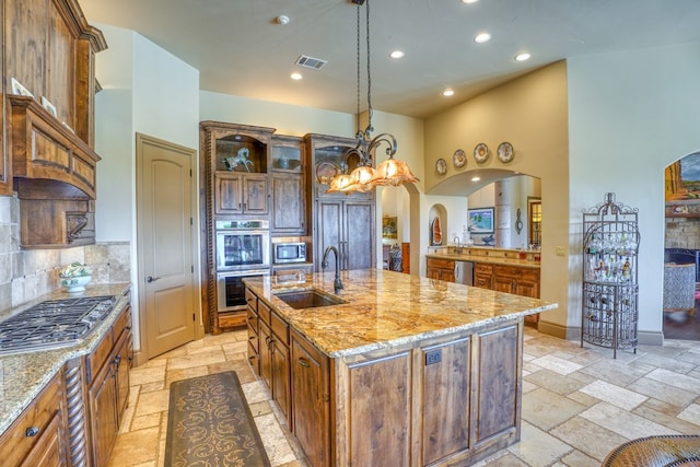 143 Westgate Loop, Horseshoe Bay, TX 78657 - kitchen featuring a sink, stone tile floors, appliances with stainless steel finishes, recessed lighting, and backsplash