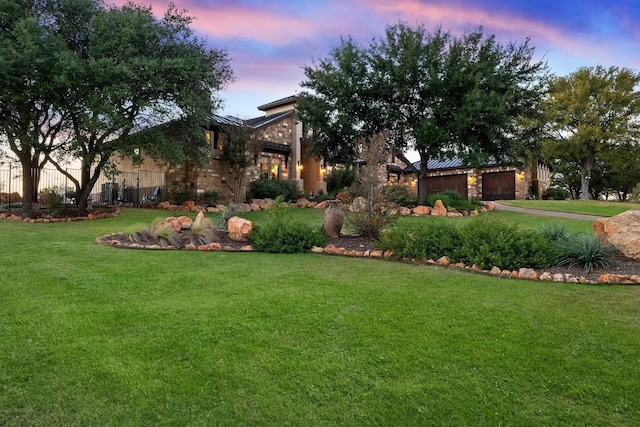 143 Westgate Loop, Horseshoe Bay, TX 78657 - view of front facade featuring a yard, an attached garage, and stone siding