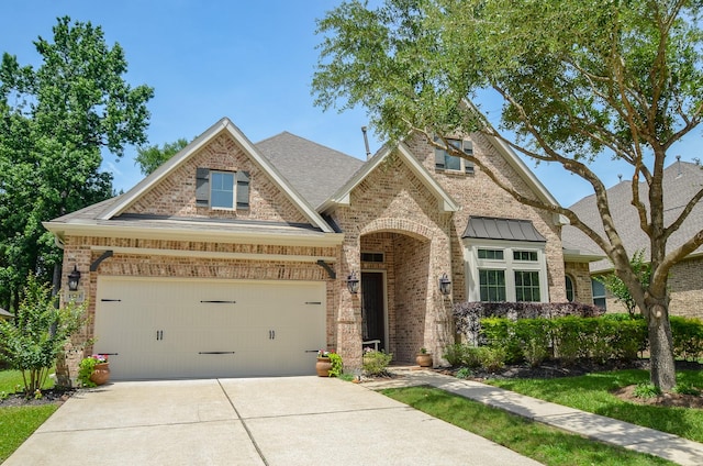 1523 Cafe Dumonde, Conroe, TX 77304 - view of front of property with brick siding, concrete driveway, a garage, and roof with shingles