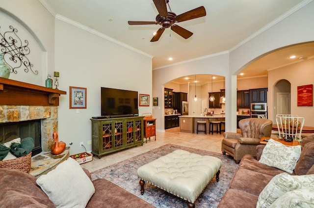 1523 Cafe Dumonde, Conroe, TX 77304 - living area with ornamental molding, ceiling fan, arched walkways, a fireplace, and recessed lighting