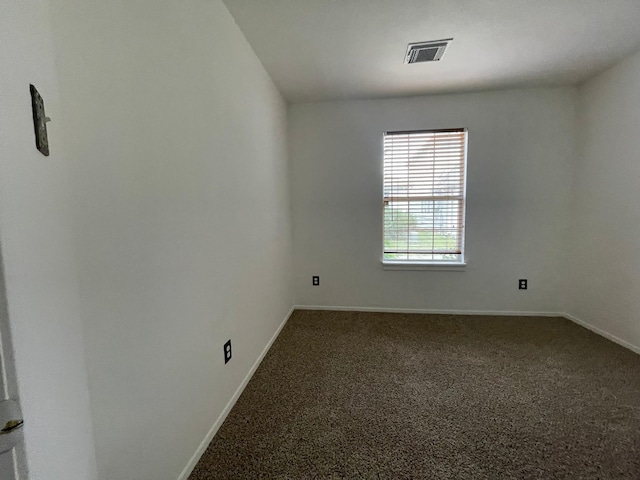 unfurnished room featuring carpet and baseboards