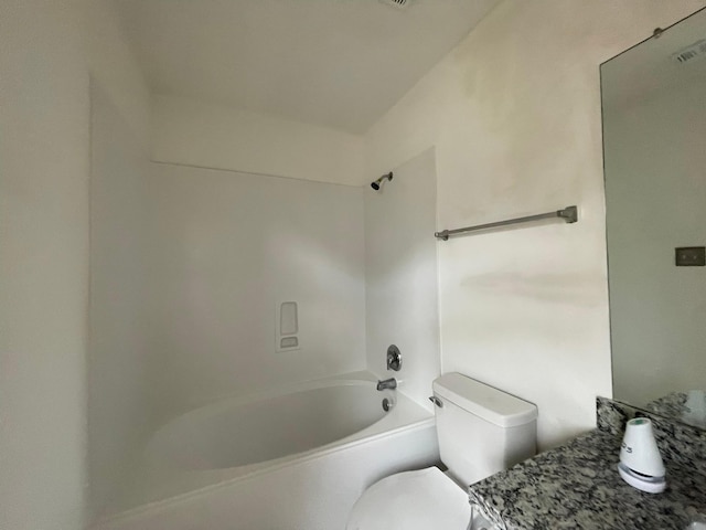 bathroom featuring bathing tub / shower combination and toilet