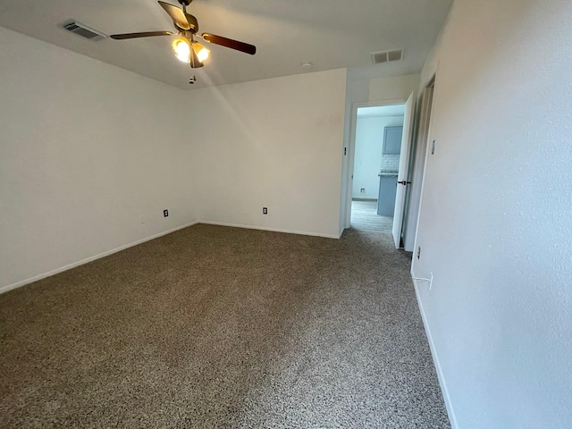 unfurnished room featuring a ceiling fan, baseboards, and dark colored carpet