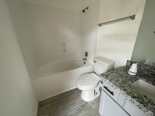 bathroom featuring shower / bathtub combination, vanity, wood finished floors, and toilet