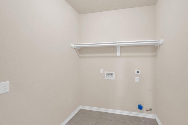 washroom featuring hookup for an electric dryer, gas dryer hookup, washer hookup, baseboards, and tile patterned floors