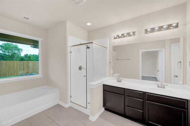 full bathroom with a shower stall, a bath, double vanity, and tile patterned floors