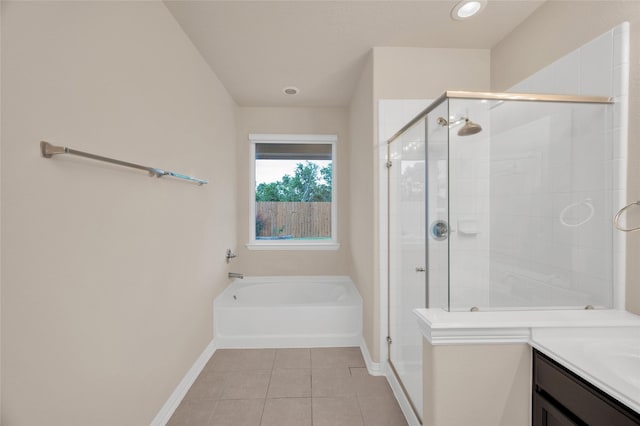 bathroom with baseboards, tile patterned floors, a shower stall, a garden tub, and recessed lighting