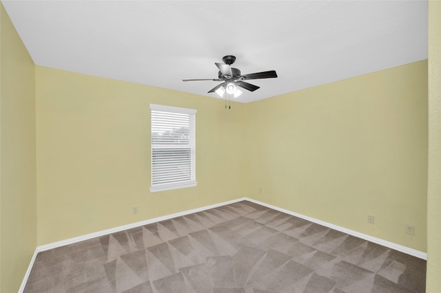 unfurnished room featuring carpet floors, ceiling fan, and baseboards