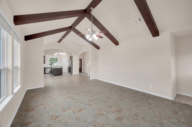 unfurnished living room featuring arched walkways, a ceiling fan, and a chandelier