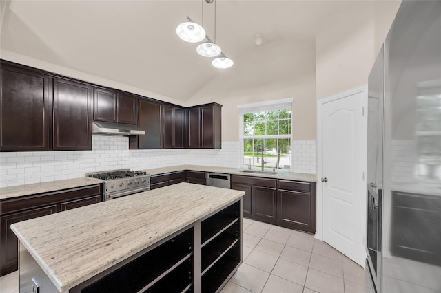 kitchen with stainless steel appliances, a sink, under cabinet range hood, tasteful backsplash, and a center island