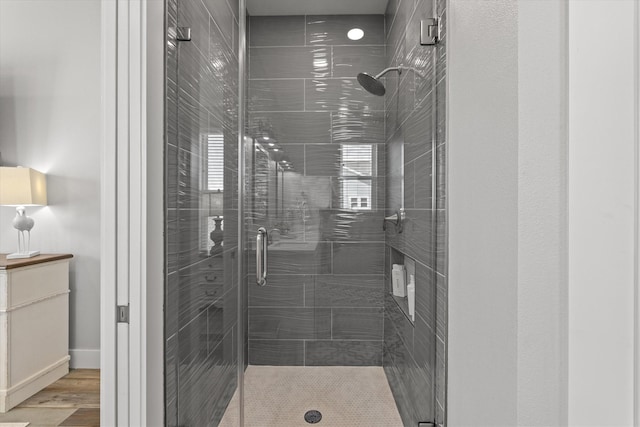 13731 Mutiny Ln, Galveston, TX 77554 - bathroom featuring a stall shower, wood finished floors, and baseboards