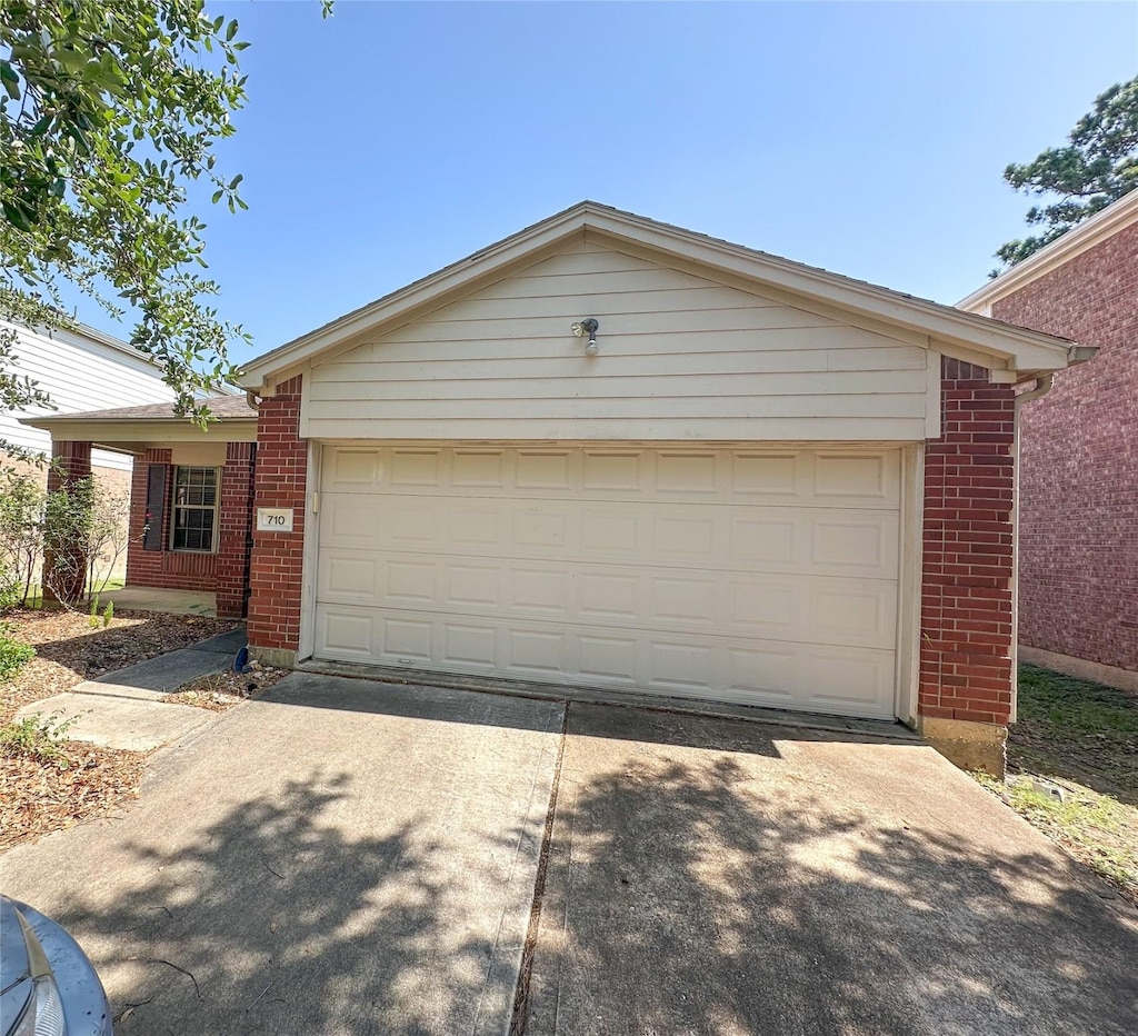 710 Cypresswood Rdg, Spring, TX 77373 - view of front of house with brick siding, driveway, and an attached garage