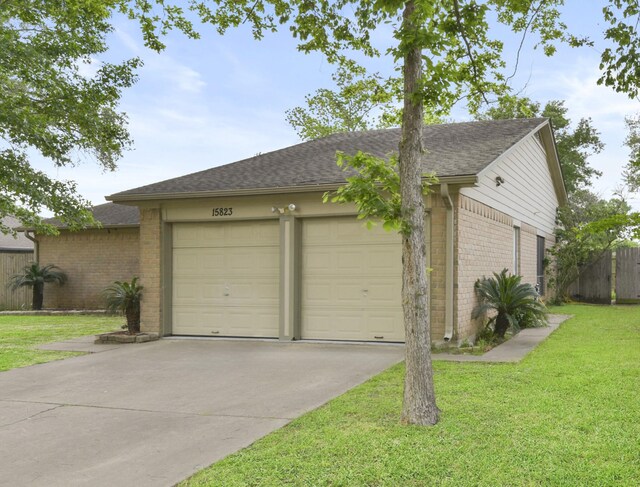 garage featuring concrete driveway