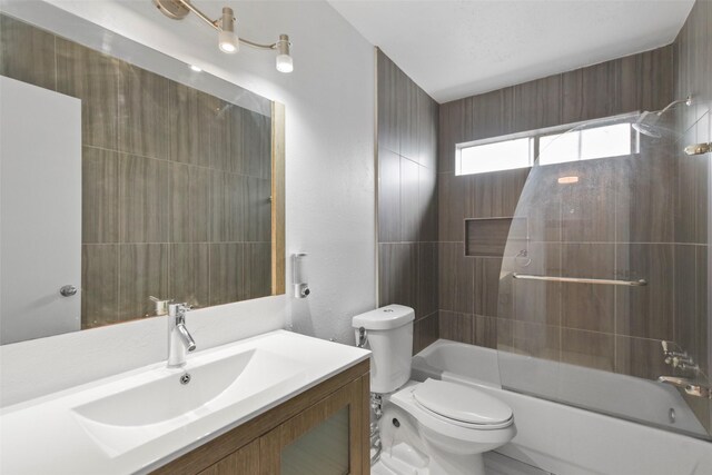 bathroom featuring toilet, vanity, and bathtub / shower combination