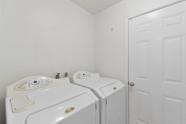 washroom with independent washer and dryer