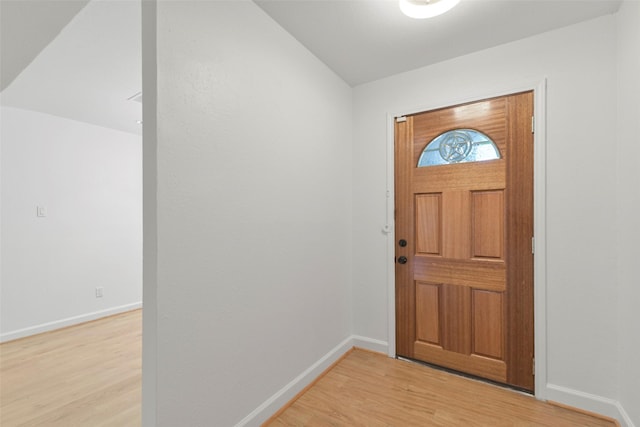 foyer with light wood-style flooring and baseboards