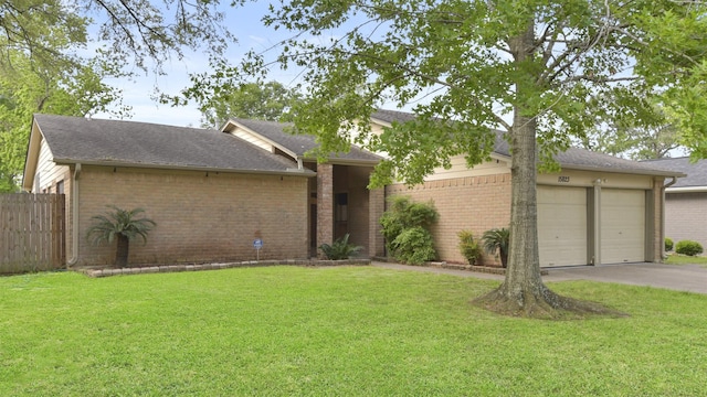 view of front of home featuring driveway, an attached garage, and brick siding