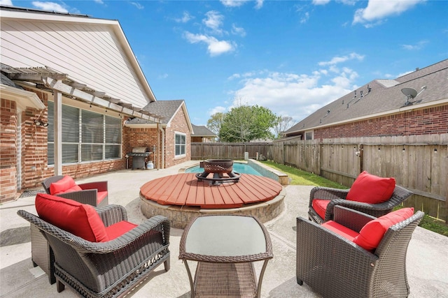 14402 Eastern Redbud Ln, Houston, TX 77044 - view of patio featuring a fire pit, a fenced backyard, and area for grilling