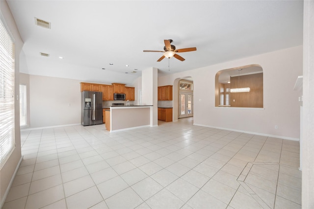 14402 Eastern Redbud Ln, Houston, TX 77044 - unfurnished living room with ceiling fan, light tile patterned flooring, arched walkways, baseboards, and recessed lighting