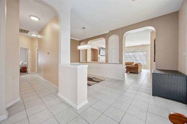 14402 Eastern Redbud Ln, Houston, TX 77044 - hallway with light tile patterned flooring, arched walkways, and baseboards