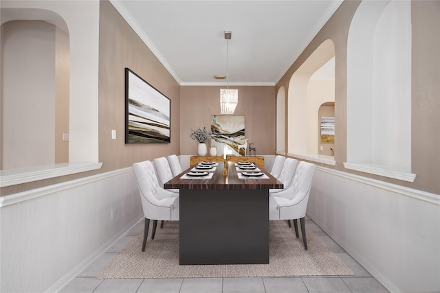 14402 Eastern Redbud Ln, Houston, TX 77044 - tiled dining space with arched walkways, ornamental molding, and wainscoting