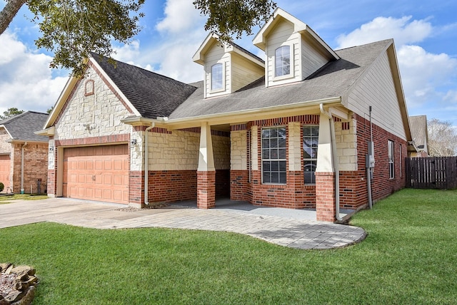 1049 Misty Clf, Dickinson, TX 77539 - view of front of home with a garage, concrete driveway, brick siding, roof with shingles, and stone siding