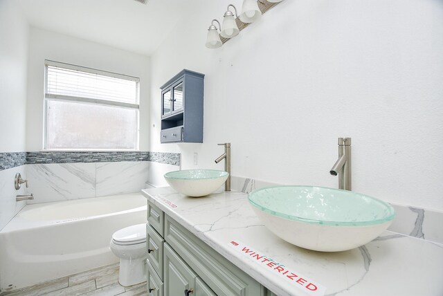 1049 Misty Clf, Dickinson, TX 77539 - full bathroom featuring double vanity, a bath, and toilet