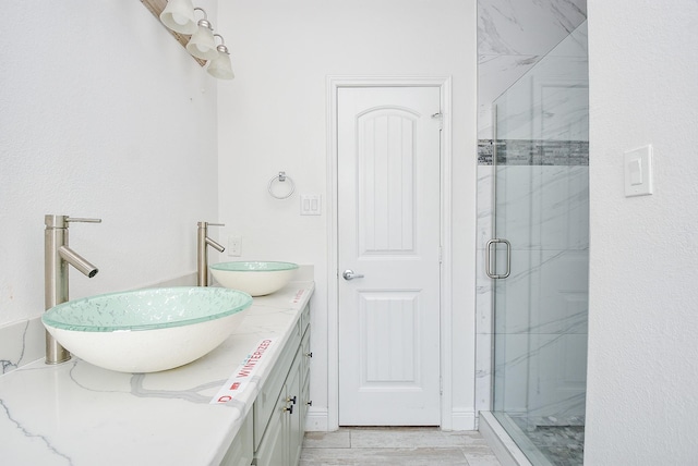 1049 Misty Clf, Dickinson, TX 77539 - full bathroom with a marble finish shower and double vanity