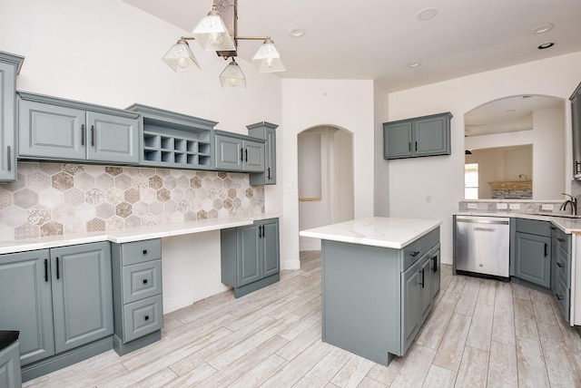 1049 Misty Clf, Dickinson, TX 77539 - kitchen featuring arched walkways, stainless steel dishwasher, light wood-style floors, decorative backsplash, and open shelves